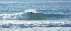 The surfing community is an integral part of the Encinitas culture. This local surfer throws spray, getting the tail of the board moving! Encinitas real estate and an ocean-centered lifestyle go hand-in-hand.